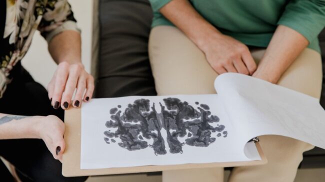 A close-up of a Rorschach inkblot test during a psychotherapy session, highlighting mental health care. - Photo by RDNE Stock project on Pexels