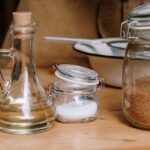 Assorted kitchen ingredients in glass jars on a wooden countertop. - Photo by cottonbro studio on Pexels