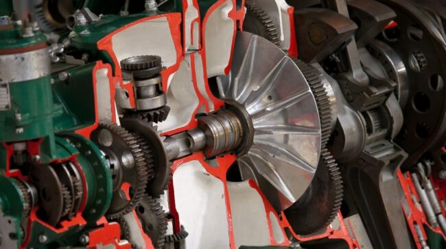 Detailed view of industrial machinery showcasing gears and cogs inside a mechanical system. - Photo by William Warby on Pexels
