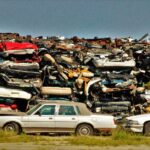A large stack of disposed vehicles in an outdoor junkyard. - Photo by Benhur Emmanuel on Pexels