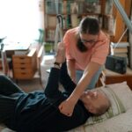 A caregiver assists an elderly man in a home environment, showcasing compassionate home care. - Photo by Jsme MILA on Pexels